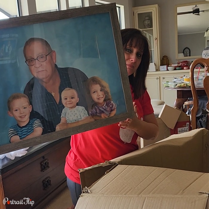 Picture of a woman holding baby portraits in her hand that include an old man with three children